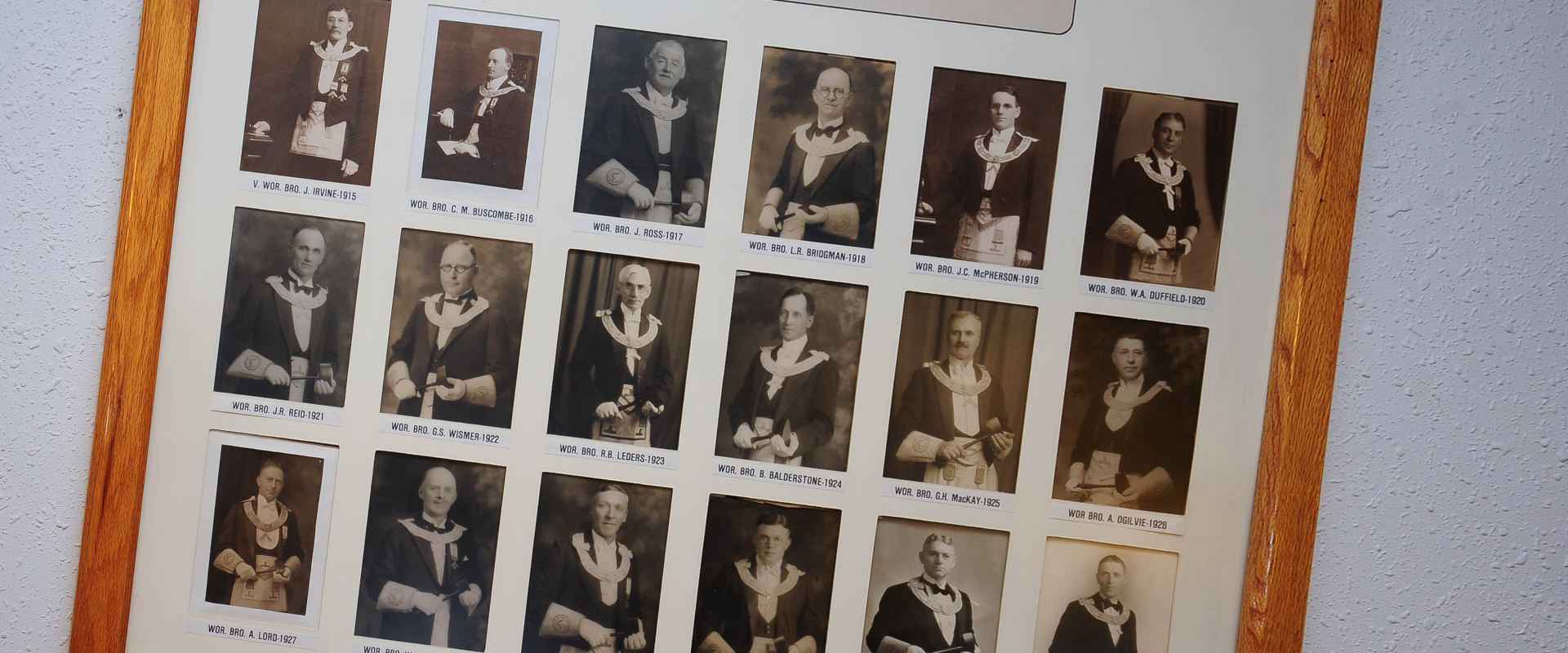 a photograph of a large picture frame with the earliest Masters of the Lodge from 1915-1932