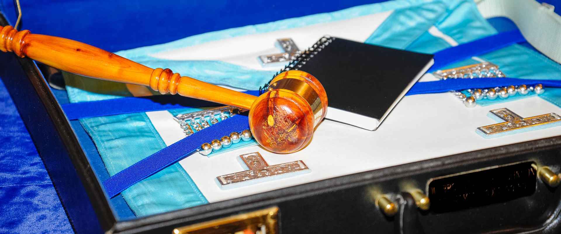a photograph of the interior of a masons briefcase showing some of his regalia.