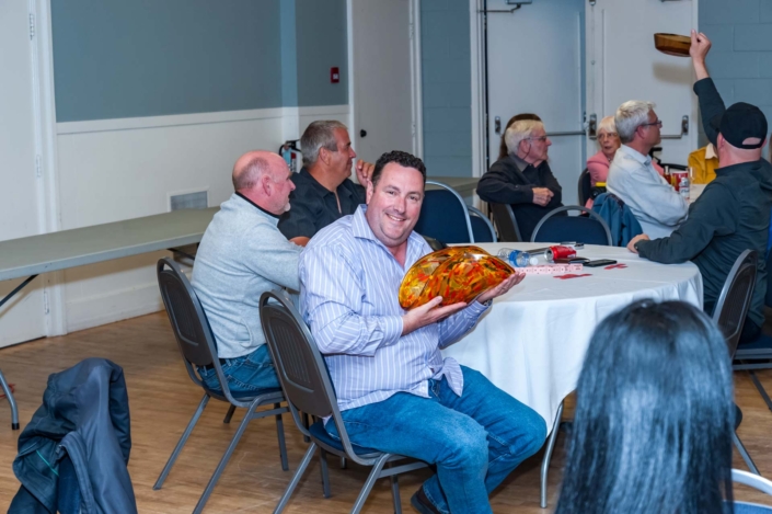 A photo of one of the guests of the ladies night dinner 2019 showing off his prize.