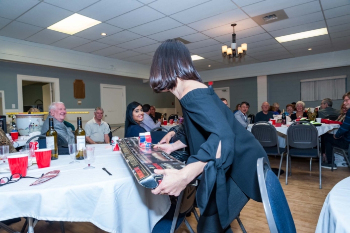 A photo of one of the members attending the Ladies night 2019 dinner swapping her prize.