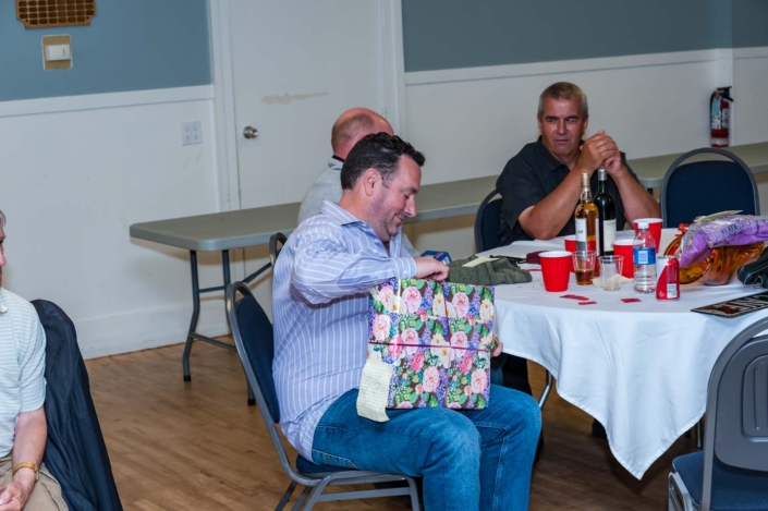 A photo of a member opening his prize.